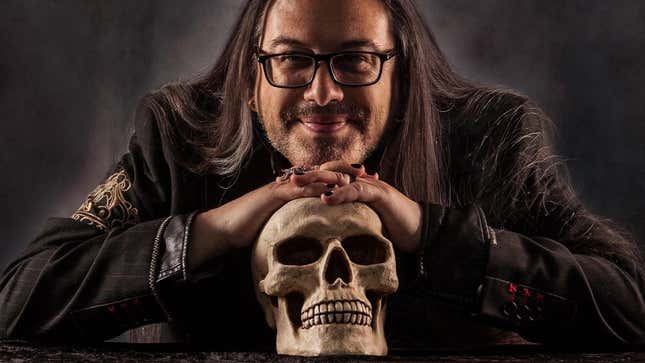 John Romero sits over a skull. 