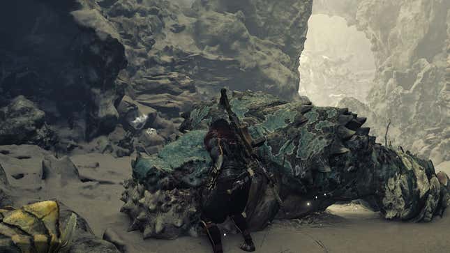 A hunter stands in front of a captured Chatacabra.