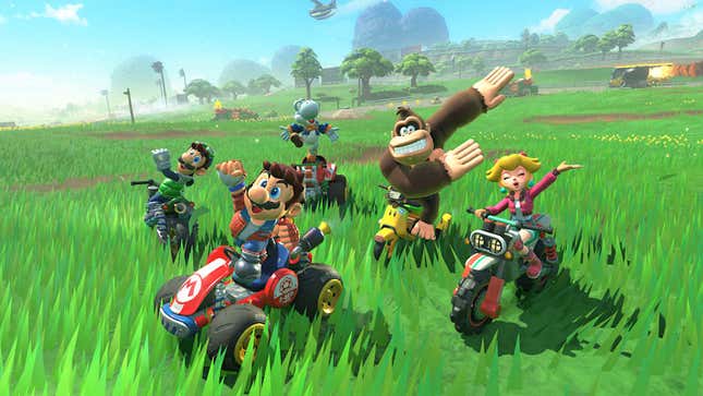 Mario and friends pose for a picture while sitting atop their vehicles in the middle of a field.