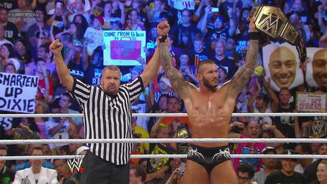 Randy Orton (right) celebrating his WWE title win with Triple H (right)